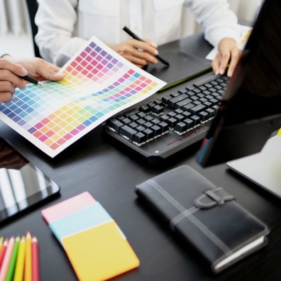 Freelance creative designer team creation project with color chart in meeting.